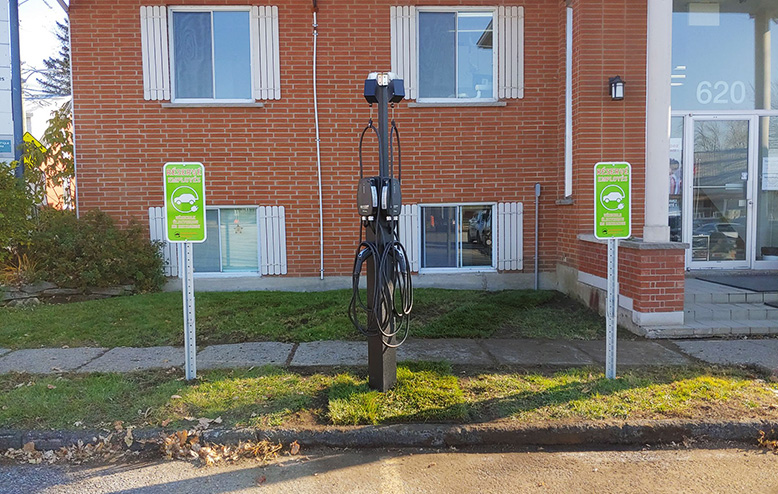 ev charging station installation on GoliathTech helical pile in front of a business